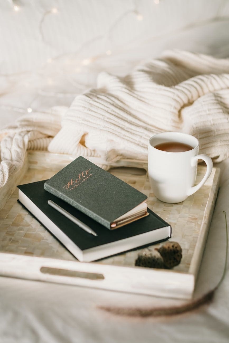 photo of cup beside books gift guide  for artists